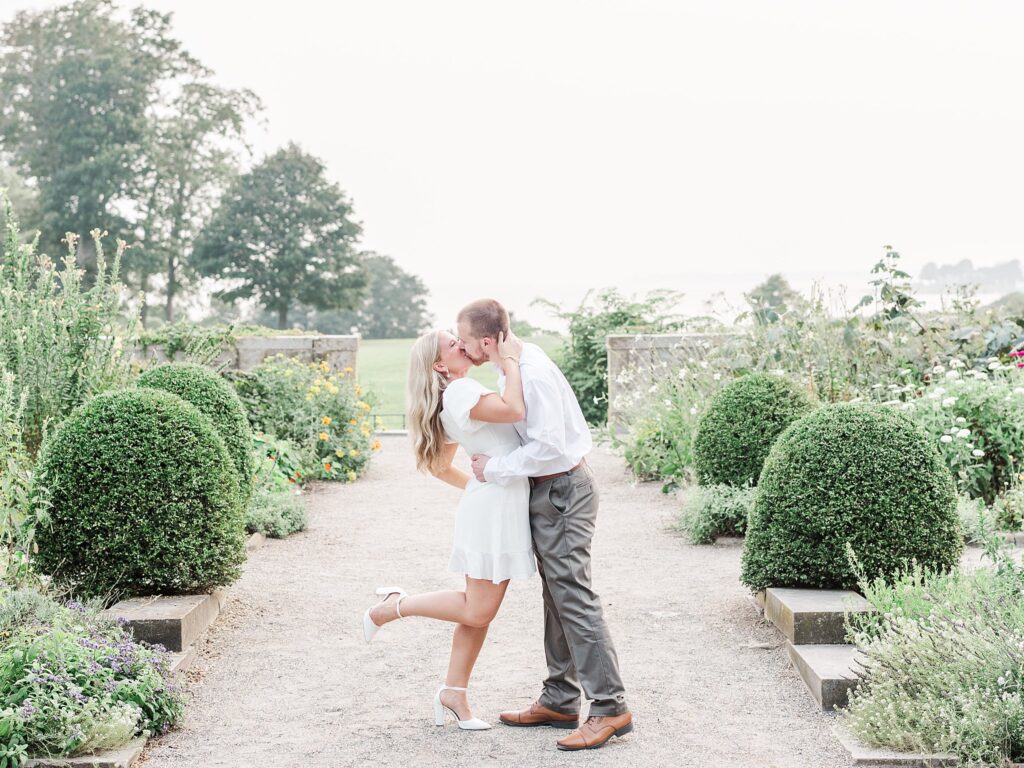 Eolia Mansion engagement portrait of a couple kissing along a garden walkway